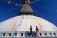 Nepal: Worshippers below the all-seeing eyes of the great dome of Bodhnath stupa, Kathmandu